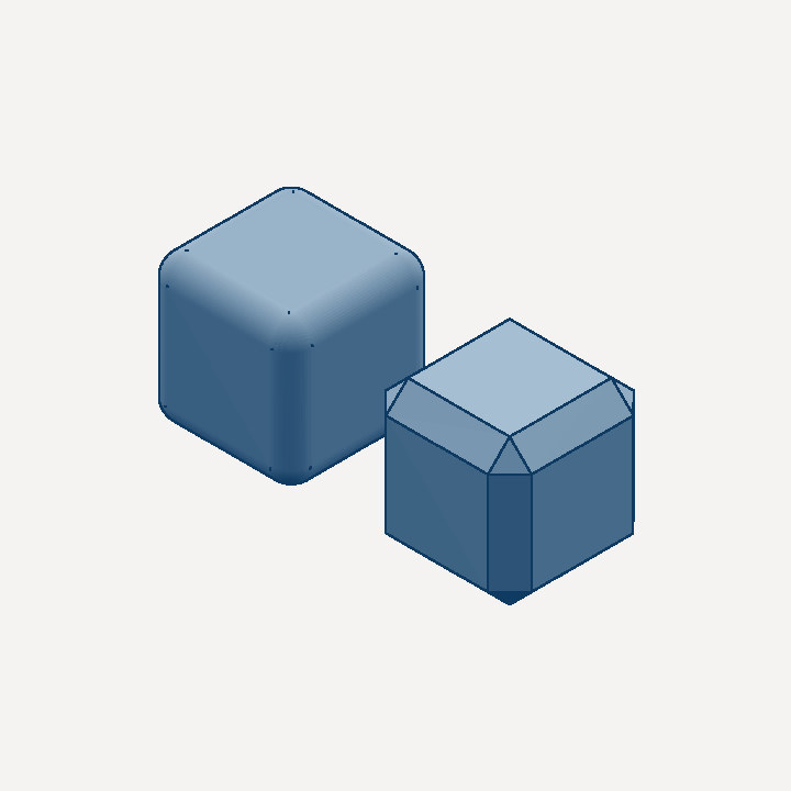 A filleted cube next to a chamfered cube